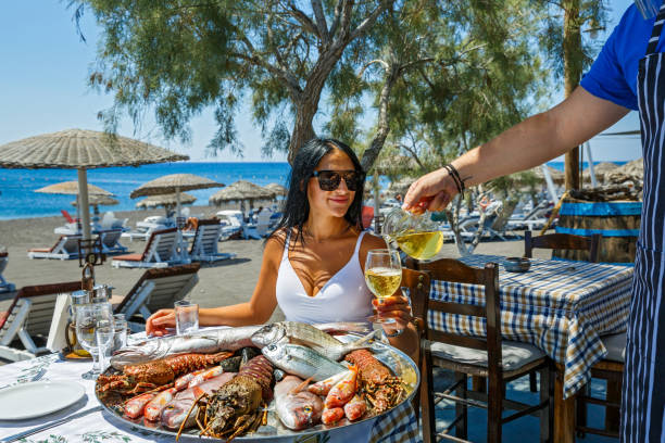 istock Young woman in a fish restaurant 1267101393