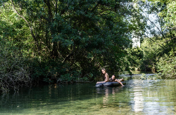 istock A woman and a child enjoy the river 1267103667