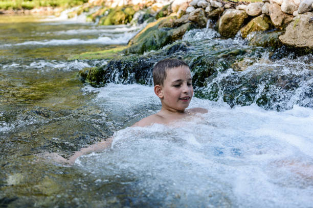 istock Little boy enjoying swimming in river 1267106087