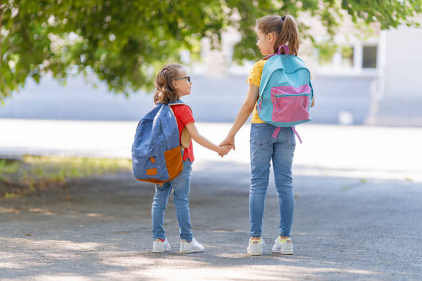 istock Girls with backpack are going to school 1267107156