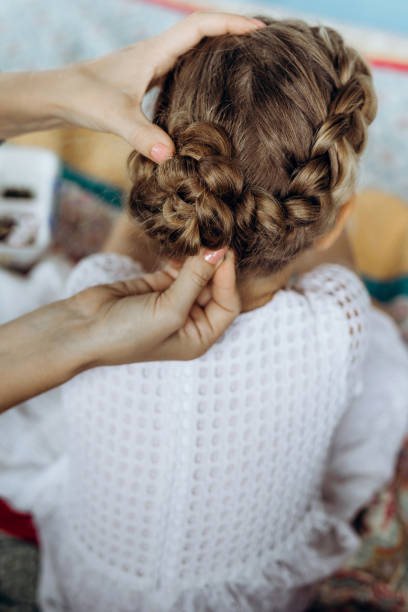 istock Mother do hair braid to her daughter 1267111211