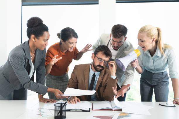istock Colleagues screaming at businessman in office 1267111309
