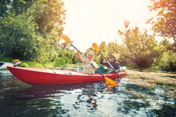 istock Happy best friends having fun on a kayaks. Kayaking on the river. 1267112621