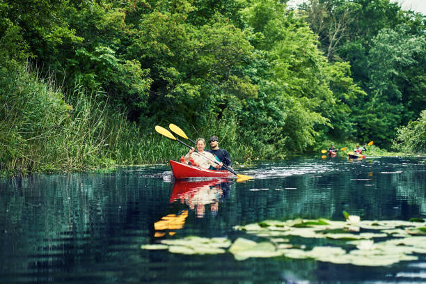 istock Happy best friends having fun on a kayaks. Kayaking on the river. 1267112624