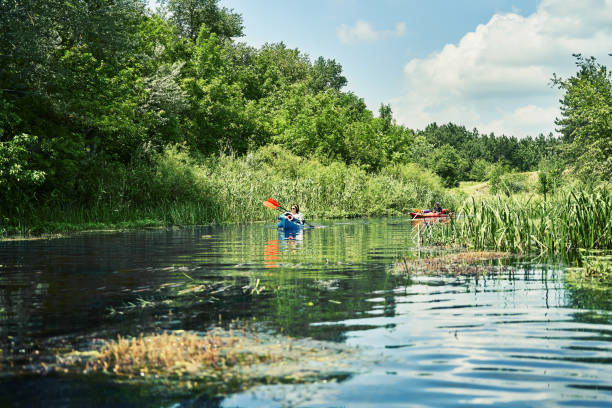 istock Happy best friends having fun on a kayaks. Kayaking on the river. 1267112626