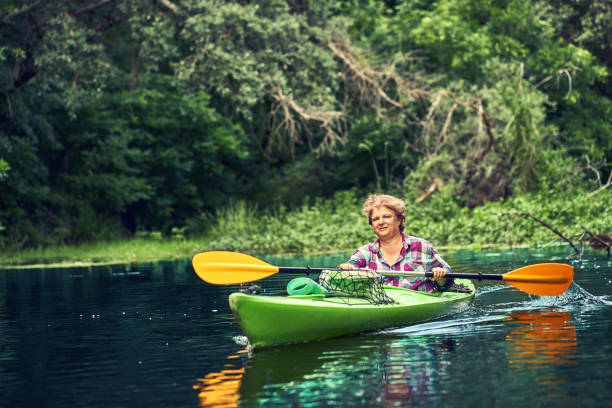 istock Happy best friends having fun on a kayaks. Kayaking on the river. 1267112891