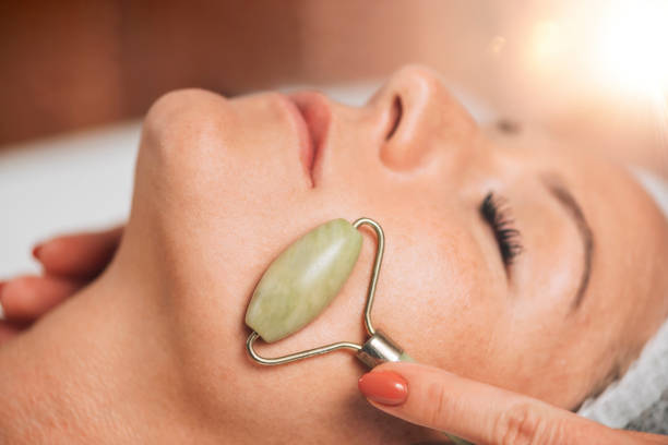 istock Anti-Aging Face Massage with Jade Roller Face Massager 1267113626