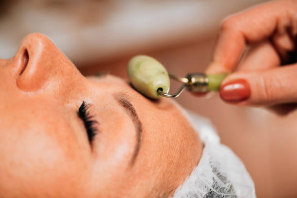 istock Anti-Aging Face Massage with Jade Roller Face Massager 1267113715