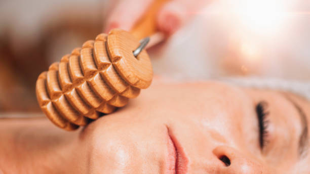 istock Maderotherapy Face Massage with Wooden Roller. Reducing Wrinkles and Sagging Cheeks 1267115515