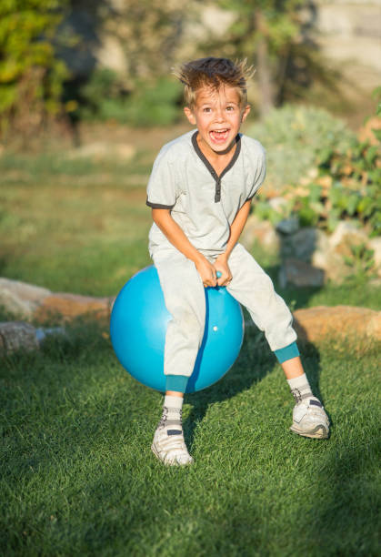 istock Small boy exercising outdoors with a big pilates ball 1267117880
