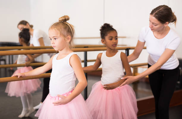istock Ballet trainer teaching two little girls 1267119854