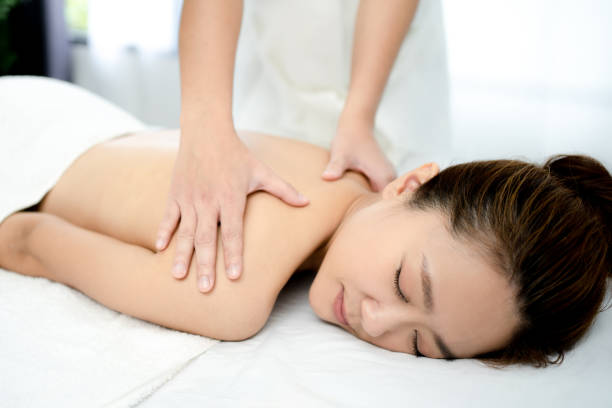istock Young woman having a relaxing massage in a spa salon. 1267122747