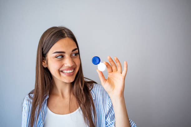 istock Woman holding contact eye lenses container 1267124953