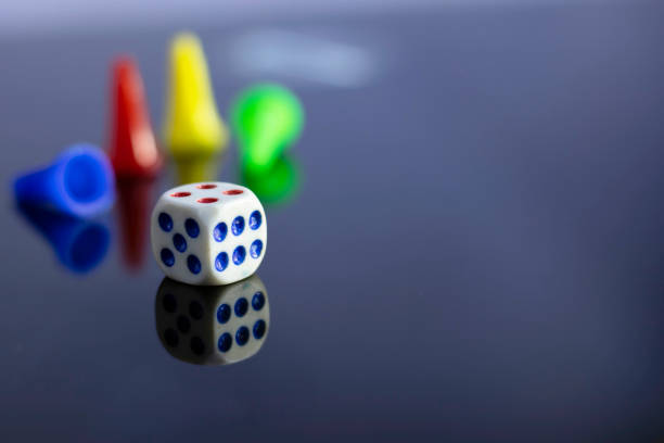 selective focus on a dice of ludo indoor game on a shiny surface