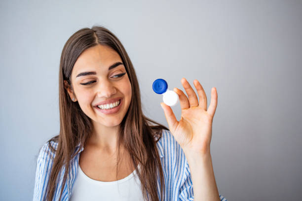 istock Woman holding contact eye lenses container 1267125246