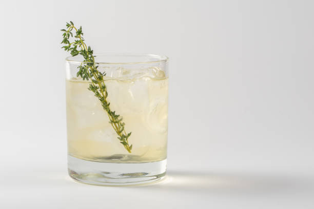 istock Alcoholic cocktail decorated with thyme in a glass glass on a white background 1267128723