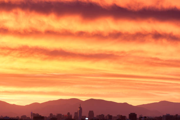 Skyline of downtown Santiago de Chile with a large cloudy sky at sunset