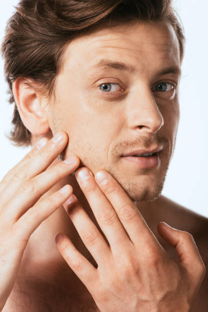 istock Shirtless man touching skin on cheek isolated on white 1267132637