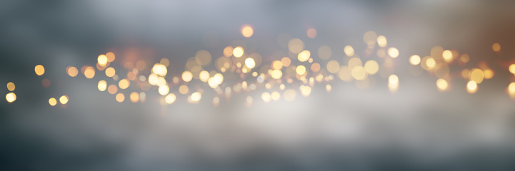 Abstract golden bokeh background with blur effects and sparks for a glamorous holiday concept.