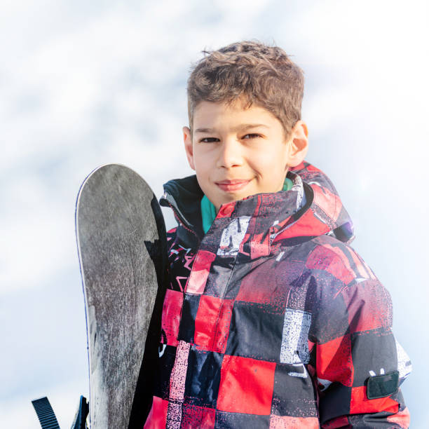 istock Portrait of Boy with Snowboard 1267133156
