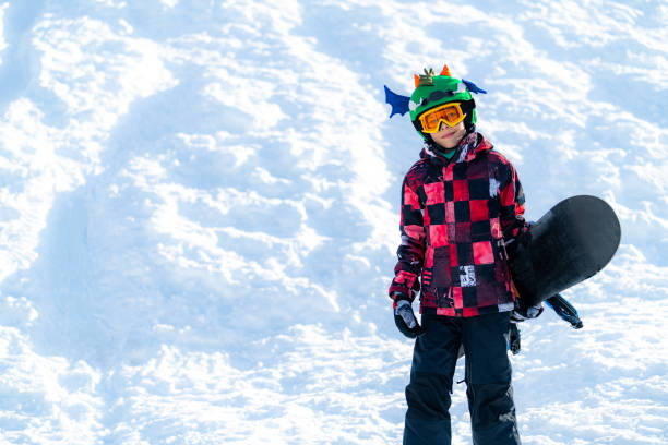 istock Portrait of Boy with Snowboard 1267133308