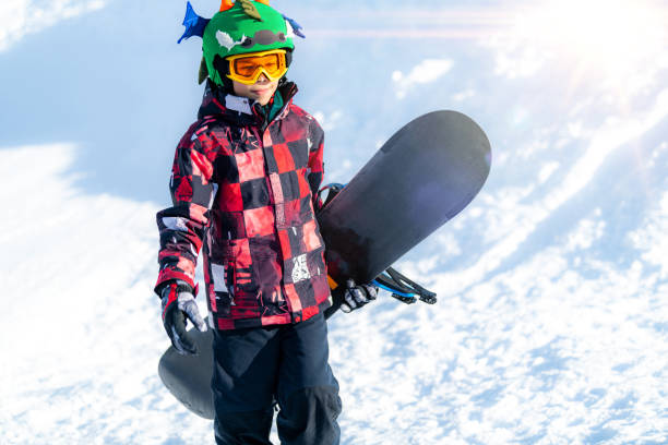 istock Portrait of Boy with Snowboard 1267133875