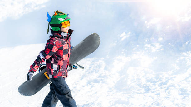 istock Boy with Snowboard in the Mountain Winter Resort 1267133949
