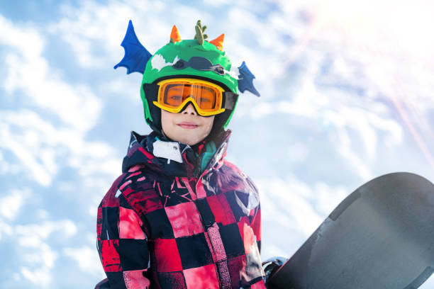 istock Portrait of Boy with Snowboard 1267134102