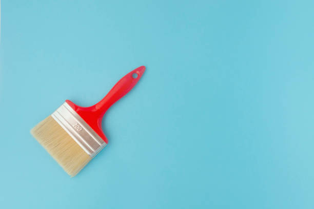 istock brush for painting on a blue background. Repair 1267135518