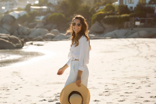 istock Dreamy elegant girl walking on the beach 1267135547