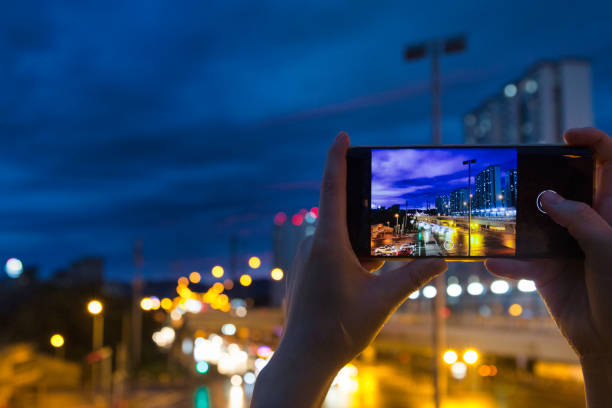 istock Take a mobile phone in both hands to shoot the city night scene 1267137708
