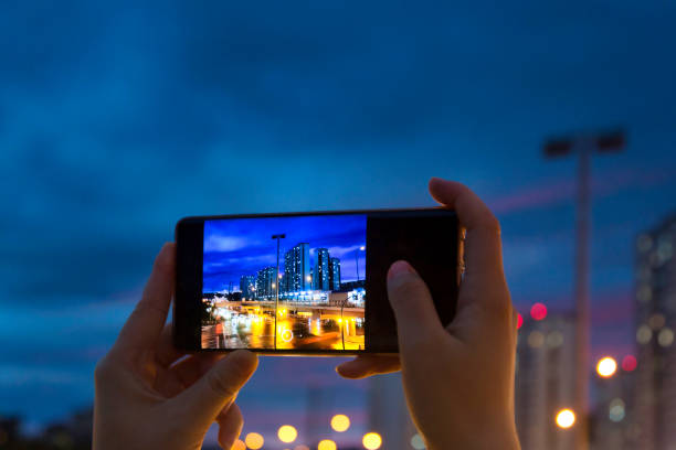 istock Take a mobile phone in both hands to shoot the city night scene 1267137739