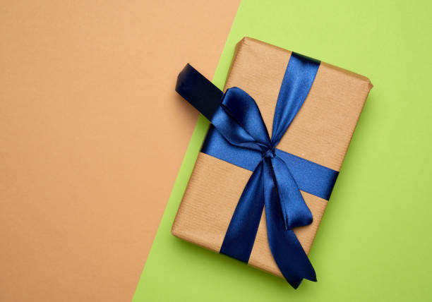 istock rectangular box wrapped in brown paper and tied with a silk ribbon with a bow 1267137841