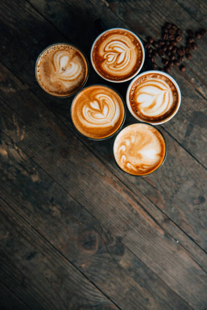 istock Coffee cups latte art on wooden table 1267141703