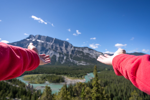 Human Hands Showing Banff and Bow River on a nice summer day