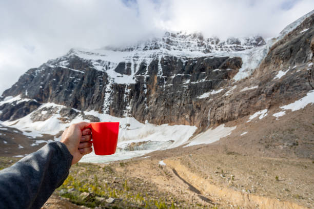 istock Human Hand Showing a coffee cup at Mount Edith Cavell, Alberta, Canada 1267143480