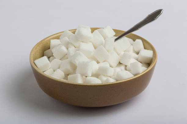 White sugar cubes on a black background.