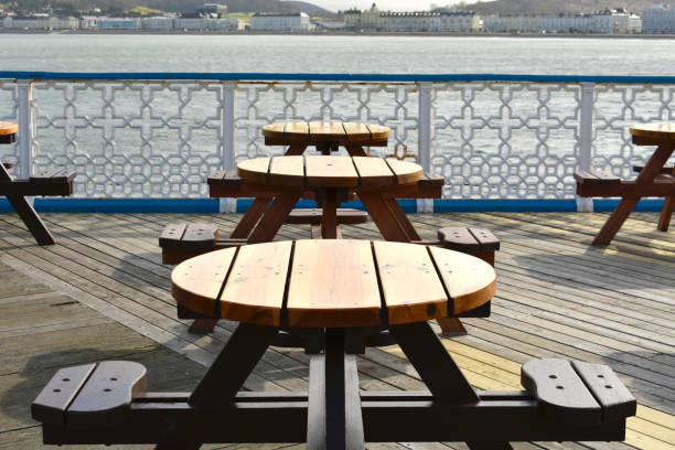 istock blue and white pier with close up of empty table and chairs outside cafe during lockdown 1267148073