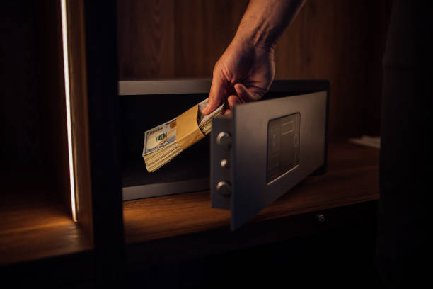 istock Putting money in the safe box. 1267148497