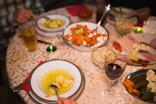 Close-up of peoples plates eating soup during family dinner at home