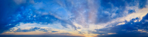 istock Magical Magnificent Blue Sky panorama at Cloudy sunset with sun rays and warm clouds 1267150836