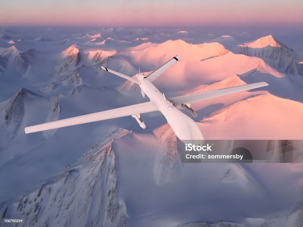 military RC military drone flies against the background of beautiful Arctic ice mountains painted pink by the sunset sun. Elements of this image furnished by NASA Unmanned Aerial Vehicle Stock Photo