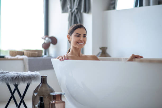 istock Relaxed young woman taking a bath at home 1267152709