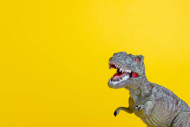 istock Dinosaur on a yellow background. Toy. Creative idea. Concept. 1267152904