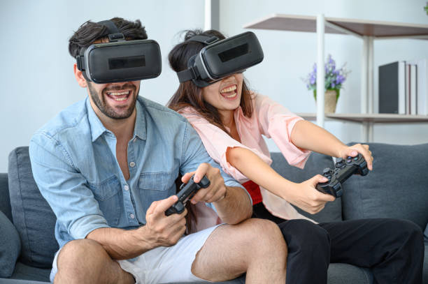 istock Couple lovers enjoy  playing VR game together at home. 1267152941