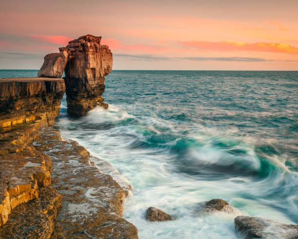 Pulpit Rock Orange Sunset A vibrant orange sunset at Pulpit Rock in Dorset England bill of portland stock pictures, royalty-free photos & images