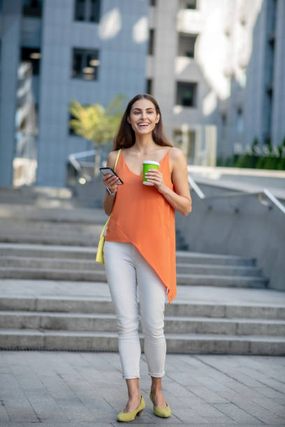 istock Smiling woman holding a coffee cup looking beautiful 1267156626