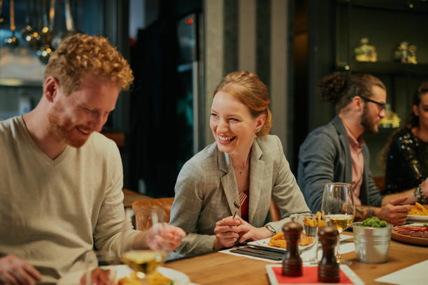 istock Friends sitting in restaurant and having dinner. 1267158750