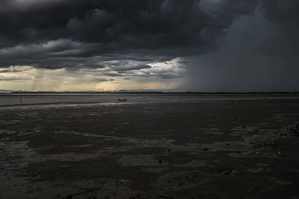 istock cloud raining  to the ocean with sunlight at sunset behide 1267158945