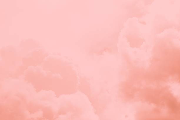 istock Pink coral fluffy clouds in the sky. Beautiful sky background 1267159513
